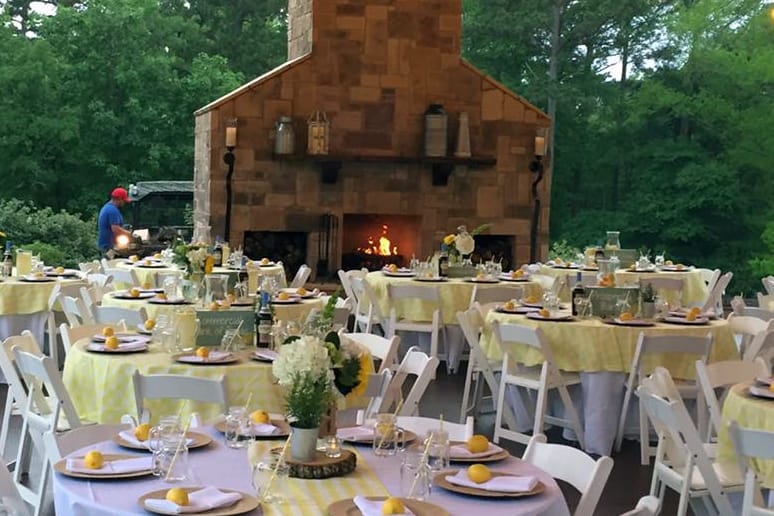 Covered outdoor table arrangement with a fireplace