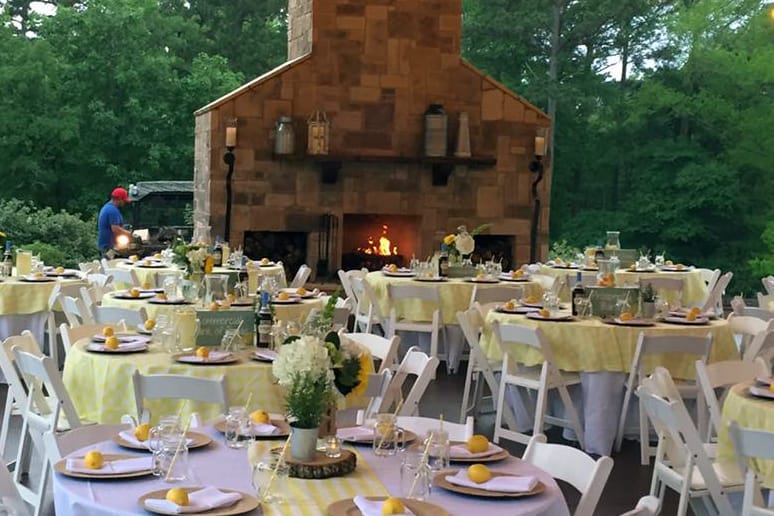 Covered outdoor table arrangement with a fireplace