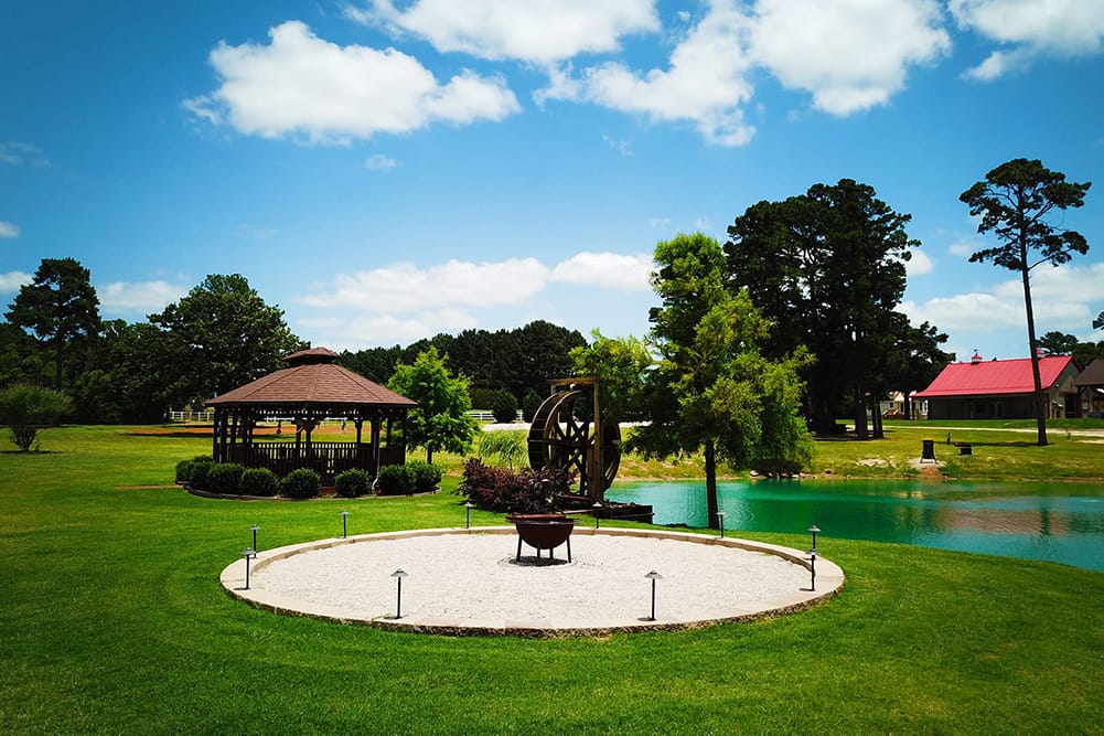 The outdoor firepit by the pond is a great place to relax