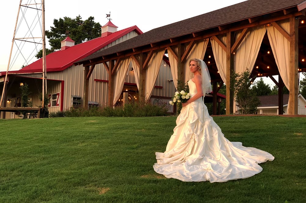 A bride in front of The Barn